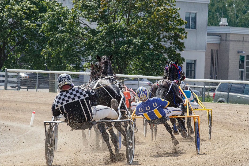 People Racing on Horses on Raceway